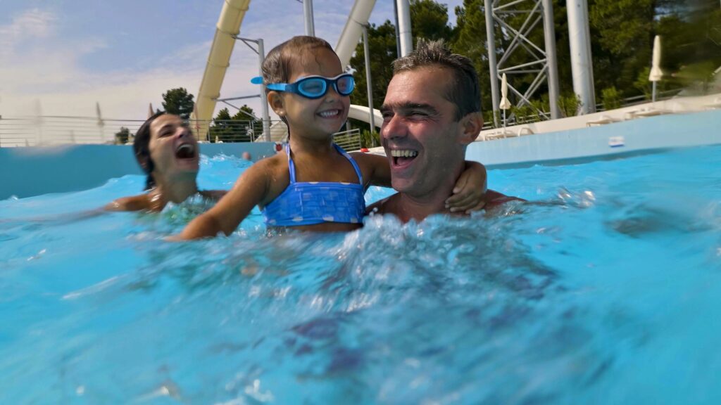 Family fun in the pool with water slide