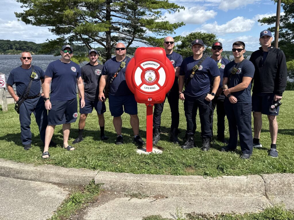 Indianapolis firefighters gathered beside a Goal Zero life ring station